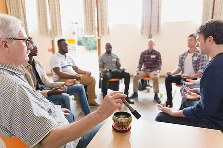 simsearch:6113-09220799,k - Man using singing bowl in meditation group Fotografie stock - Premium Royalty-Free, Codice: 6113-09220829