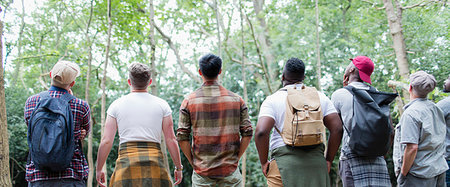 Mens group hiking, standing in a row and bird watching in woods Stock Photo - Premium Royalty-Free, Code: 6113-09239779