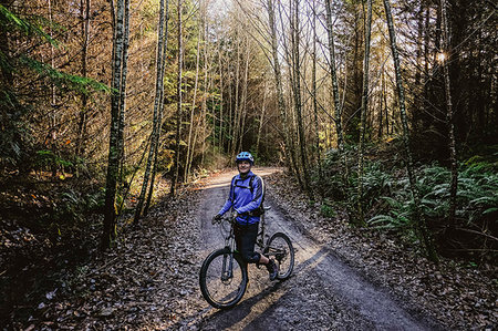 Portrait confident man mountain biking in autumn woods, Squamish, BC, Canada Stock Photo - Premium Royalty-Free, Code: 6113-09239841