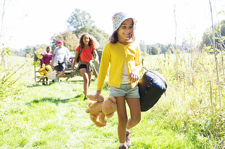 simsearch:6113-09240050,k - Girl camping with family, carrying sleeping bag and teddy bear Stock Photo - Premium Royalty-Free, Code: 6113-09239861