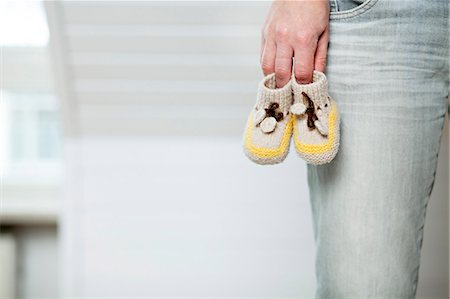 Person Holding Baby Booties, Munich, Bavaria, Germany Stock Photo - Premium Royalty-Free, Code: 6115-06778535
