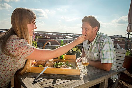 Woman Feeding Man On Balcony, Munich, Bavaria, Germany, Europe Stockbilder - Premium RF Lizenzfrei, Bildnummer: 6115-06778663