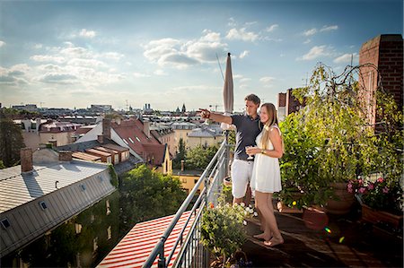 smile woman urban europe - Young Couple On Balcony, Munich, Bavaria, Germany, Europe Stock Photo - Premium Royalty-Free, Code: 6115-06778667