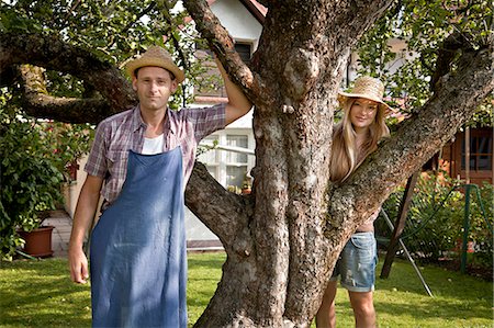 simsearch:6115-06778642,k - Mid adult couple stands next to apple tree in garden, Munich, Bavaria, Germany Stock Photo - Premium Royalty-Free, Code: 6115-06778615