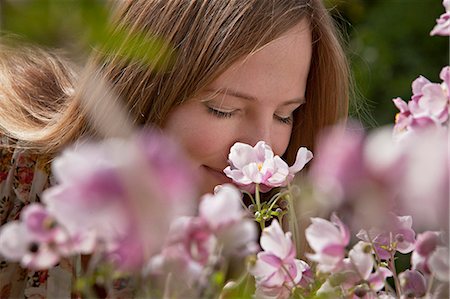 simsearch:6115-08066527,k - Mid adult woman smelling flowers, Munich, Bavaria, Germany Stock Photo - Premium Royalty-Free, Code: 6115-06778635