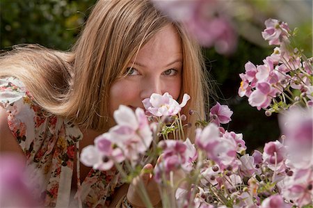 simsearch:6115-08066527,k - Mid adult woman smelling flowers, Munich, Bavaria, Germany Stock Photo - Premium Royalty-Free, Code: 6115-06778636