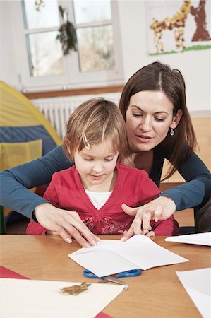 folding - Teacher And Little Girl In Nursery School, Kottgeisering, Bavaria, Germany, Europe Stock Photo - Premium Royalty-Free, Code: 6115-06778745