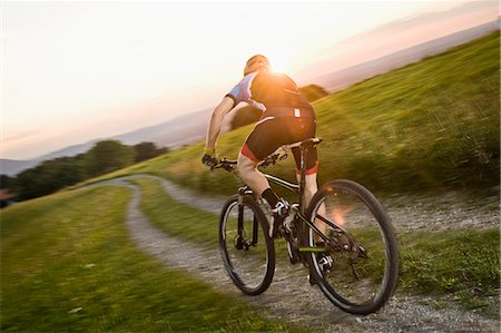 simsearch:6115-06778772,k - Mountain biker riding on a trail at sunset, Samerberg, Germany Stock Photo - Premium Royalty-Free, Code: 6115-06778765