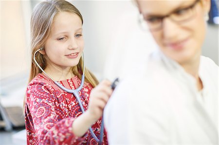 expert and child - Girl is using playfully a stethoscope on female doctor, Osijek, Croatia Stock Photo - Premium Royalty-Free, Code: 6115-06778948