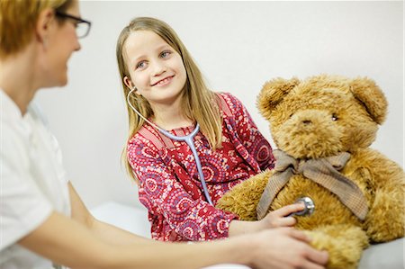 doctor and kid - Girl is using playfully a stethoscope on a teddy bear, Osijek, Croatia Stock Photo - Premium Royalty-Free, Code: 6115-06778949