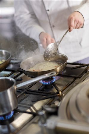 Cook In Commercial Kitchen Foto de stock - Sin royalties Premium, Código: 6115-06778976