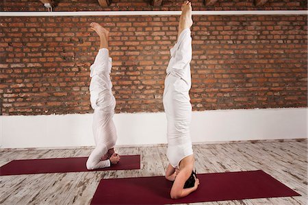 simsearch:6115-06778907,k - Couple Doing Headstand Stock Photo - Premium Royalty-Free, Code: 6115-06778903