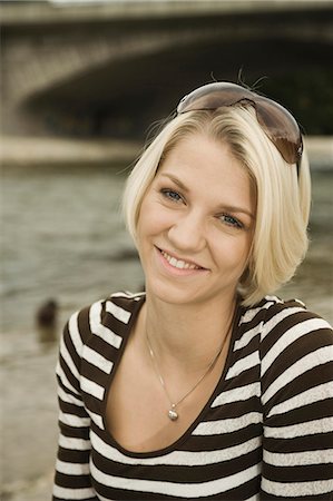 simsearch:6115-06778922,k - Young woman in a stripy shirt outdoors, portrait, Munich, Bavaria, Germany Foto de stock - Sin royalties Premium, Código: 6115-06778913
