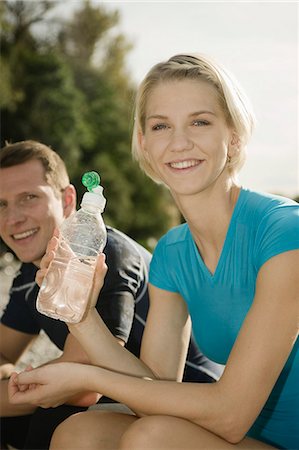 simsearch:6115-06778922,k - Young woman holding water bottle, man in background, Munich, Bavaria, Germany Foto de stock - Sin royalties Premium, Código: 6115-06778932
