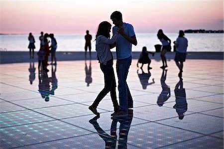 even - Croatia, Dalmatia, Solar panels as a dance floor, sunset in background Foto de stock - Sin royalties Premium, Código: 6115-06732877