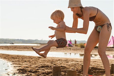 sand castle and parent and child - Croatia, Dalmatia, Mother And Son On Sandy Beach Stock Photo - Premium Royalty-Free, Code: 6115-06732895
