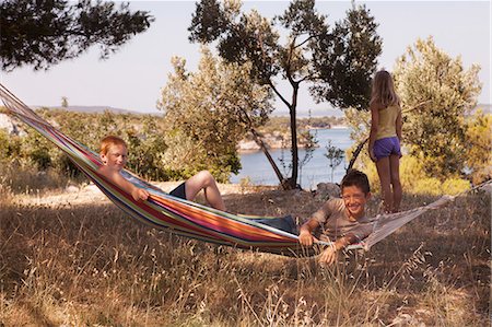 simsearch:6115-06732835,k - Croatia, Dalmatia, Children playing in hammock on camping site Photographie de stock - Premium Libres de Droits, Code: 6115-06732824