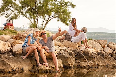 smartphone at beach - Croatia, Dalmatia, Young people at the seaside Stock Photo - Premium Royalty-Free, Code: 6115-06733083