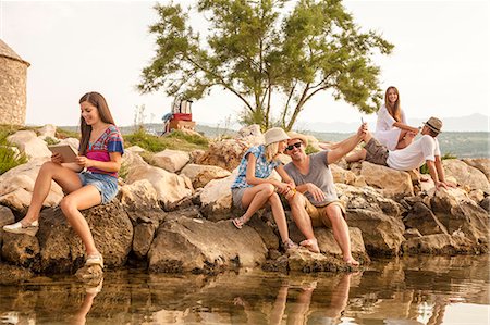 smartphone at beach - Croatia, Dalmatia, Young people at the seaside Stock Photo - Premium Royalty-Free, Code: 6115-06733082