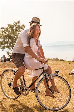 people balancing bicycle picture - Croatia, Dalmatia, Young couple at the seaside, riding a bike Stock Photo - Premium Royalty-Free, Code: 6115-06733089