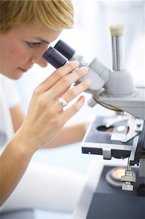 physician testing test - Female Scientist looks through a microscope Stock Photo - Premium Royalty-Free, Code: 6115-06733180