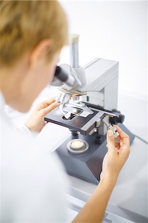 physician testing test - Female Scientist looks through a microscope Stock Photo - Premium Royalty-Free, Code: 6115-06733181