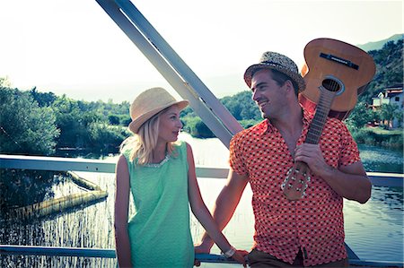 friends guitar outside - Croatia, Dalmatia, Young couple on a footbridge, man with guitar Stock Photo - Premium Royalty-Free, Code: 6115-06733112