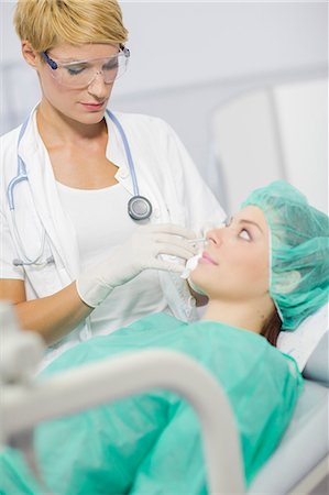 plastic surgery woman face - Patient in Treatment Stock Photo - Premium Royalty-Free, Code: 6115-06733255