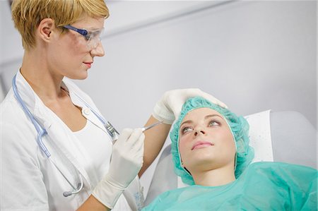 female doctor cap - Patient In Treatment Stock Photo - Premium Royalty-Free, Code: 6115-06733271