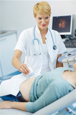 pregnant woman with doctor - Pregnant woman having an ultrasound Stock Photo - Premium Royalty-Free, Code: 6115-06733296