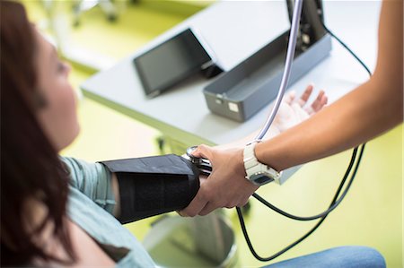 doctor examine woman only - Blood Pressure Testing Stock Photo - Premium Royalty-Free, Code: 6115-06733310