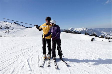 simsearch:6115-06966977,k - Young couple standing on a ski slope, Sudelfeld, Bavaria, Germany Stock Photo - Premium Royalty-Free, Code: 6115-06966978