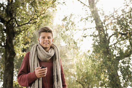 Teenage boy using phone in forest, Bavaria, Germany, Europe Stock Photo - Premium Royalty-Free, Code: 6115-06967149