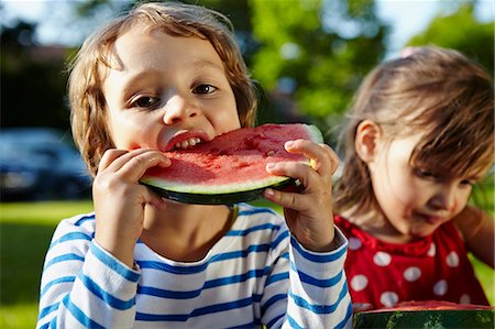Children eating water melons, Munich, Bavaria, Germany Stock Photo - Premium Royalty-Free, Code: 6115-07109677