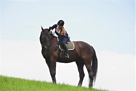 person riding horse - Woman Riding Horse in Rural Landscape, Baden Wuerttemberg, Germany, Europe Stock Photo - Premium Royalty-Free, Code: 6115-07109621