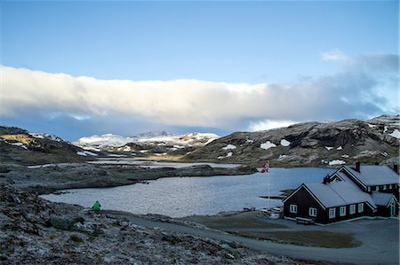 Settlement in a fjord, hiker in foreground, Norway, Europe Stock Photo - Premium Royalty-Free, Code: 6115-07109749