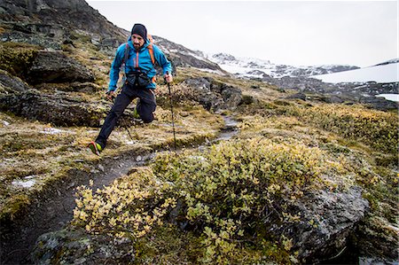 Hiker jumping along mountain trail, Norway, Europe Stock Photo - Premium Royalty-Free, Code: 6115-07109781