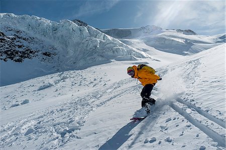 simsearch:6115-06967096,k - Man snowboarding in mountain scenery, European Alps, Tyrol, Austria Stock Photo - Premium Royalty-Free, Code: 6115-07109733