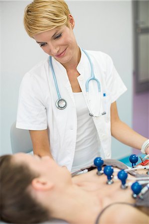 ecg electrodes - Female patient undergoing electrocardiogram, Munich, Bavaria, Germany Stock Photo - Premium Royalty-Free, Code: 6115-07109892