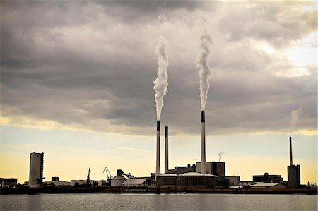 pollution - Power plant with huge smoke stacks on the waterfront, Denmark, Europe Stock Photo - Premium Royalty-Free, Code: 6115-07109805