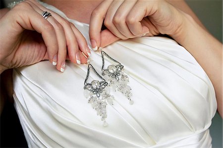 simsearch:6115-07109837,k - Bride showing earrings against wedding dress, Zagreb, Croatia Stock Photo - Premium Royalty-Free, Code: 6115-07109831