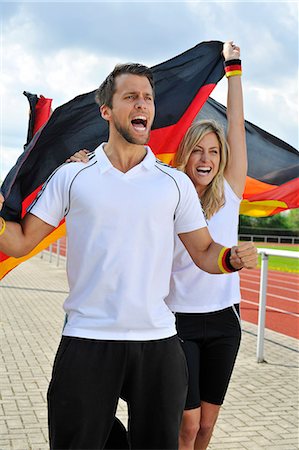 excited sport fan - Soccer fans waving German flag, Munich, Bavaria, Germany Foto de stock - Sin royalties Premium, Código: 6115-07109914