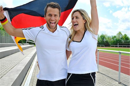 Soccer fans waving German flag, Munich, Bavaria, Germany Fotografie stock - Premium Royalty-Free, Codice: 6115-07109915