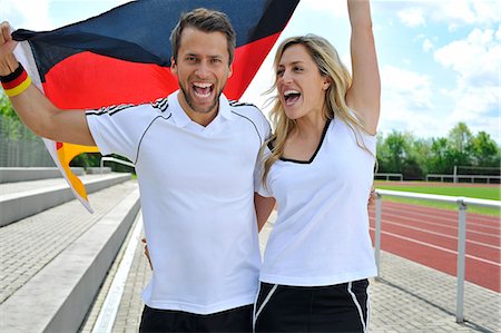 sports fan cheering - Soccer fans waving German flag, Munich, Bavaria, Germany Stock Photo - Premium Royalty-Free, Code: 6115-07109915