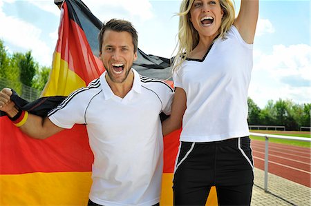 simsearch:6115-07109919,k - Soccer fans waving  German flag, Munich, Bavaria, Germany Photographie de stock - Premium Libres de Droits, Code: 6115-07109916