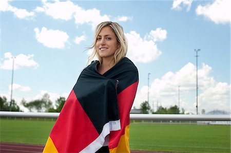 fan - Female soccer fan wrapped in German flag, Munich, Bavaria, Germany Photographie de stock - Premium Libres de Droits, Code: 6115-07109919