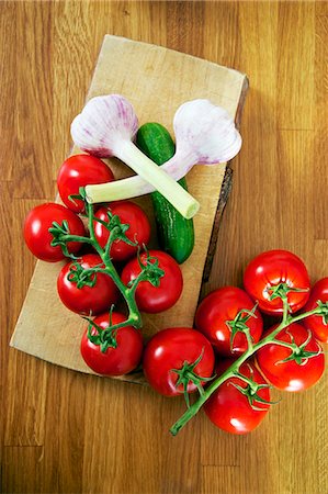 raw ingredients on board - Fresh Tomatoes And Garlic Stock Photo - Premium Royalty-Free, Code: 6115-07282689