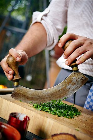 simsearch:6115-08066614,k - Man Chopping Fresh Herbs Stock Photo - Premium Royalty-Free, Code: 6115-07282761