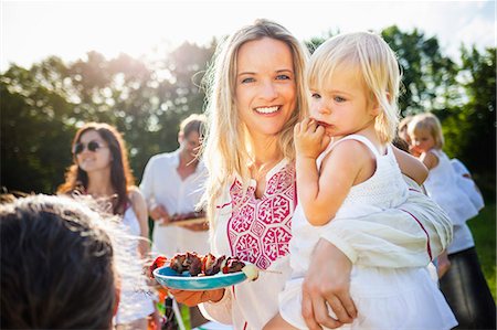 friends, 40, outside - Family with children barbecuing on the riverside, foothills of the Alps, Bavaria, Germany Stock Photo - Premium Royalty-Free, Code: 6115-07282777