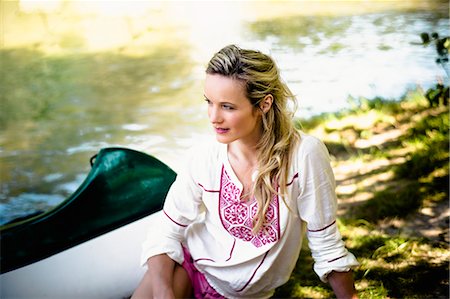 female canoeing - Young woman sits on the riverside, foothills of the Alps, Bavaria, Germany Stock Photo - Premium Royalty-Free, Code: 6115-07282785